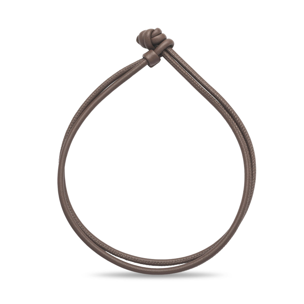 Brown leather cord bracelet on a white background