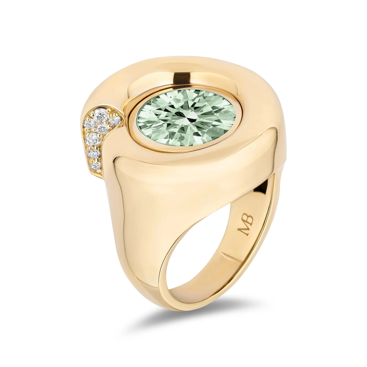A yellow gold signet ring featuring a large round light green center stone and a curved row of small clear accent stones on the side, shown on a clean white background.