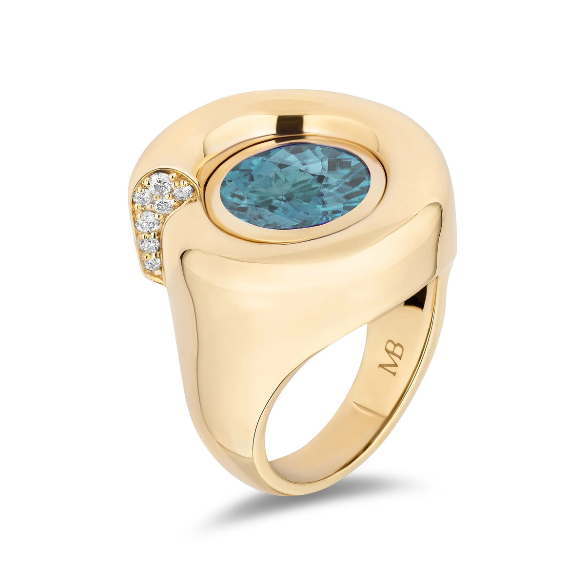 A yellow gold ring with a large oval blue gemstone and a curved row of small clear accent diamond on the side, shown on a clean white background.
