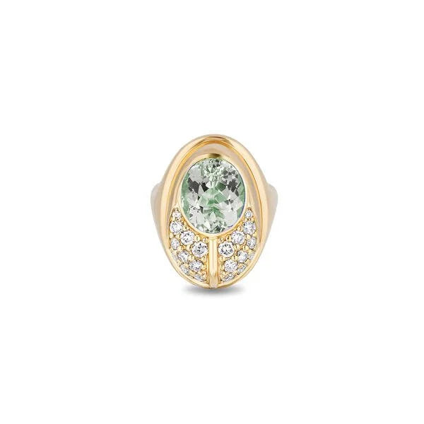 A gold ring featuring an oval-cut light prasiolite in the center, surrounded by small pavé-set diamonds on a white background.