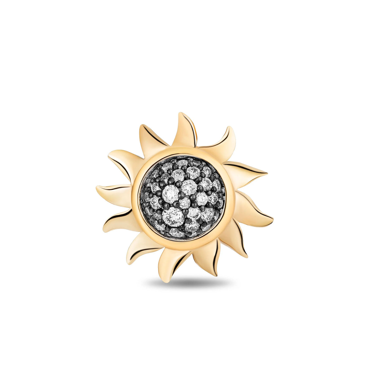 A gold sun-shaped charm or pendant with a central cluster of clear pavé stones on a white background.
