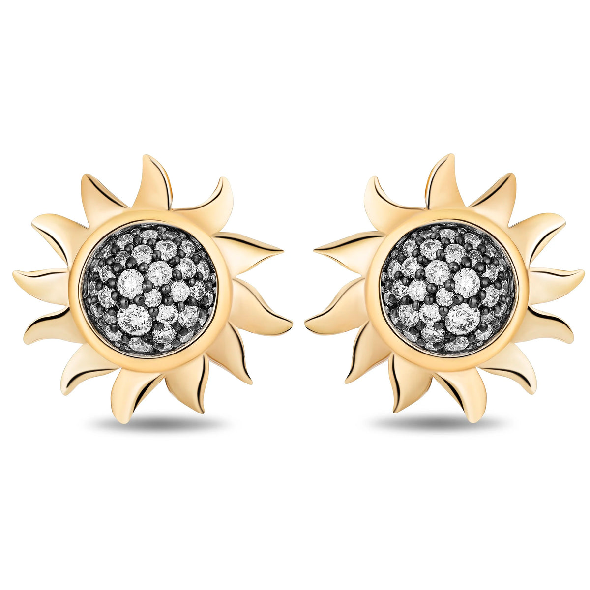 A pair of gold sunburst stud earrings with black and silver pavé diamond centers, shown on a clean white background.