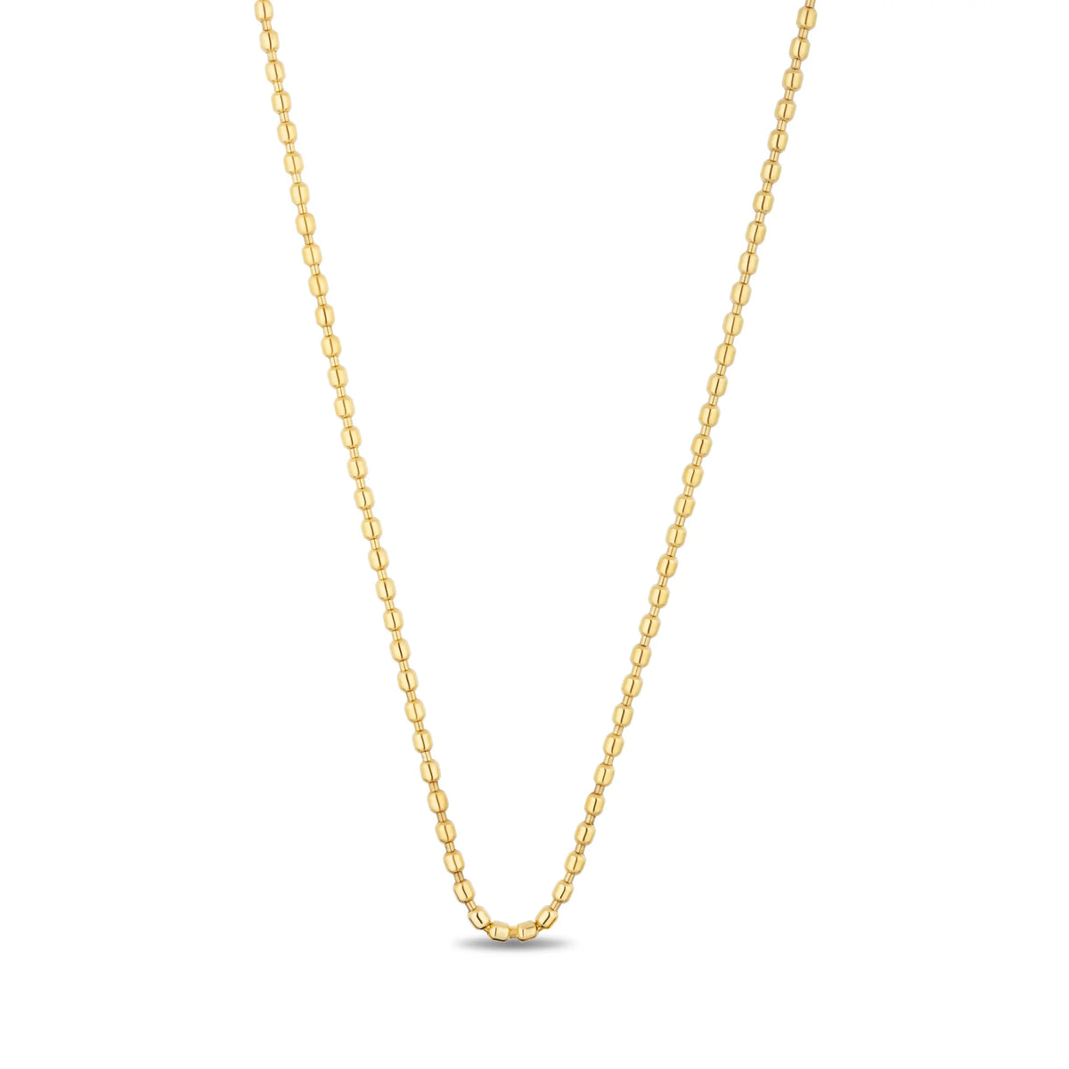 A delicate yellow gold chain necklace with elongated oval links, displayed in a V-shape against a clean white background.