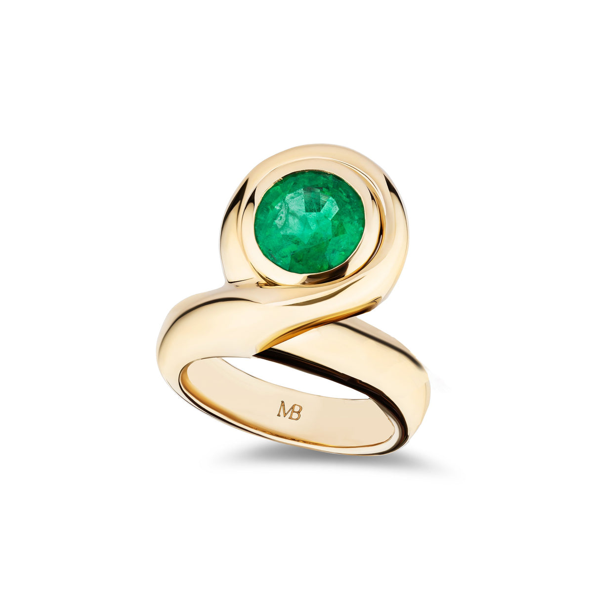 A gold ring with a round green emerald-cut gemstone, featuring a sculptural twisted band with an engraved 'MB' mark inside, set against a clean white background.