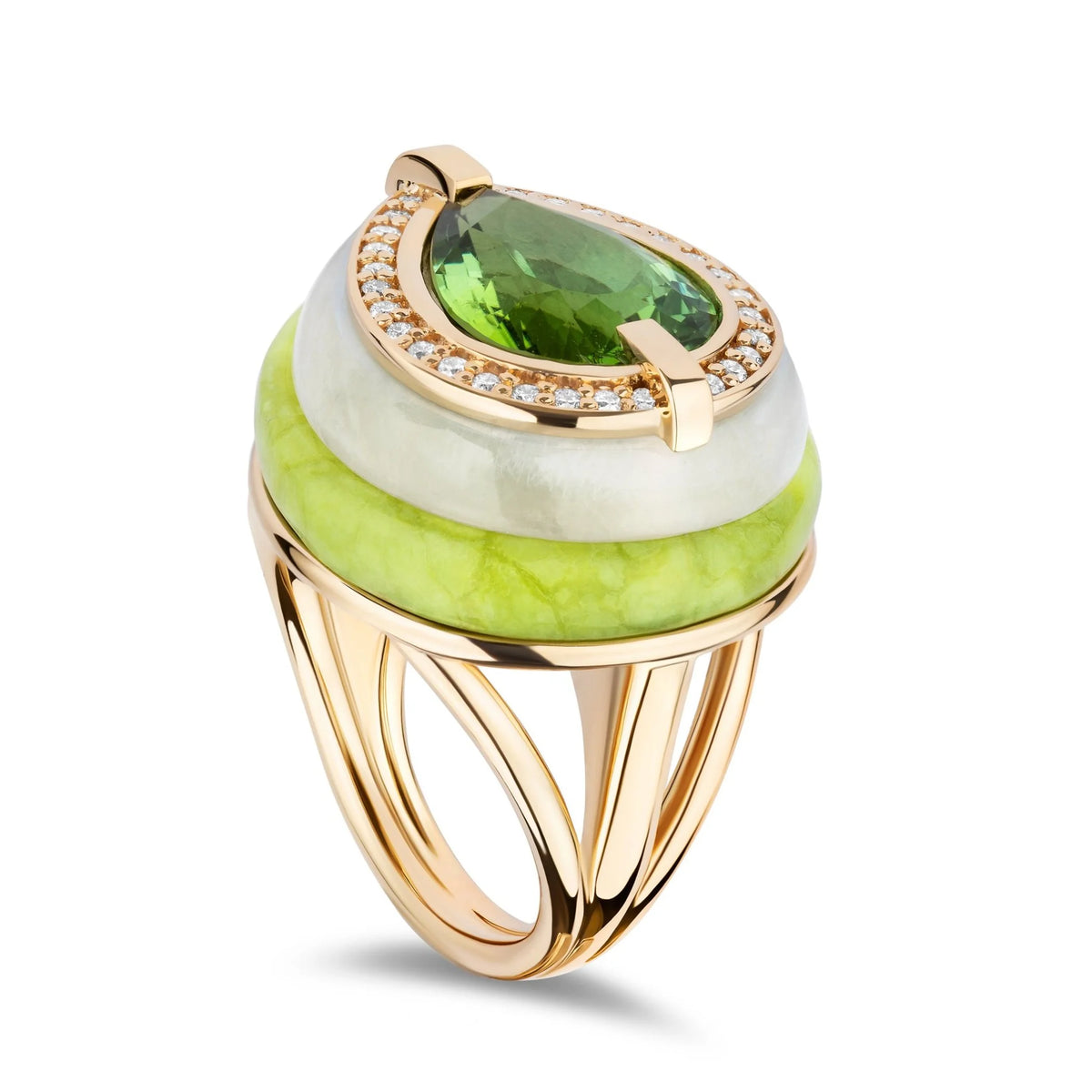 A gold ring featuring a large oval green gemstone surrounded by a halo of small clear stones, with stacked round beads in white and light green on a white background.