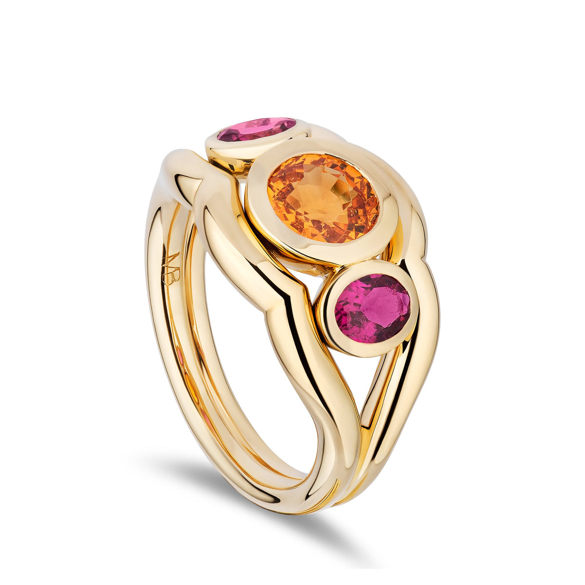 A yellow gold ring with three round-cut gemstones in pink, orange, and pink, set against a clean white background.