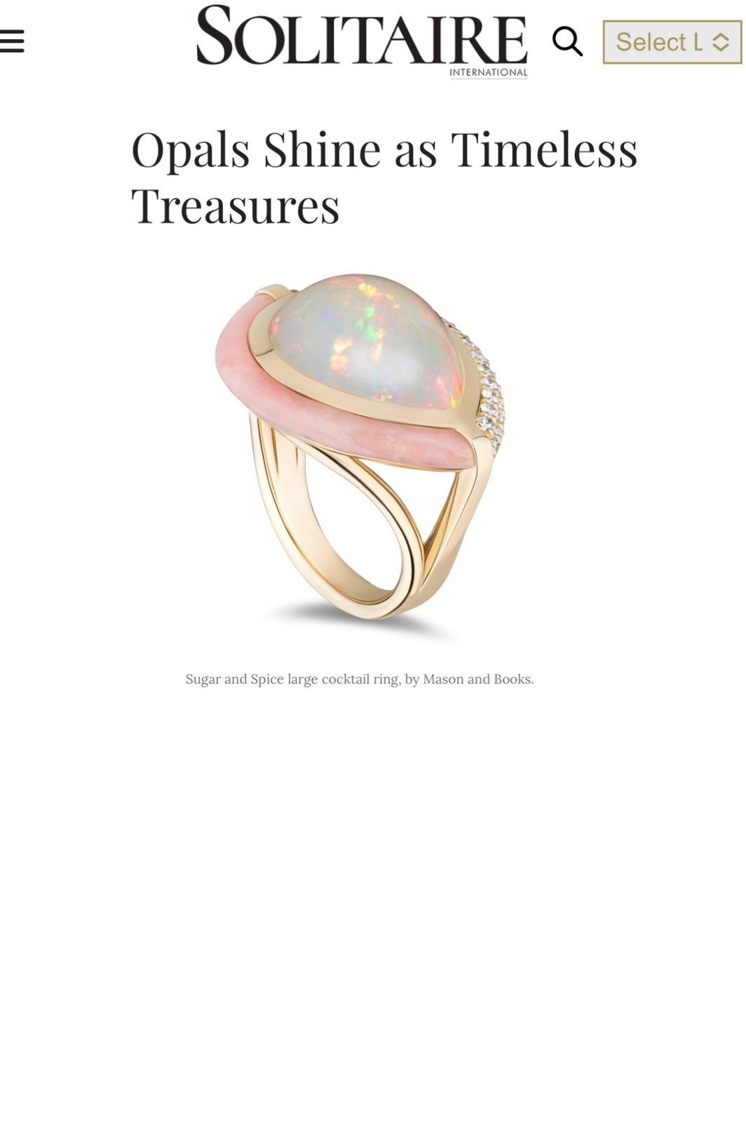 A gold cocktail ring with a large opal gemstone, pink accents, and small diamonds on the band.