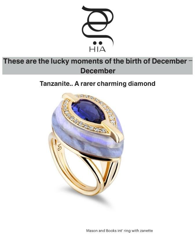 A gold ring featuring a large Tanzanite gemstone surrounded by small diamonds, with a unique band design.
