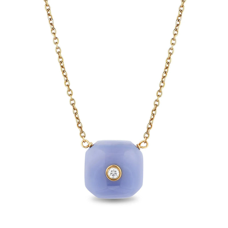 A necklace with a gold chain and a large, light blue, cube-shaped pendant featuring a single clear gemstone.