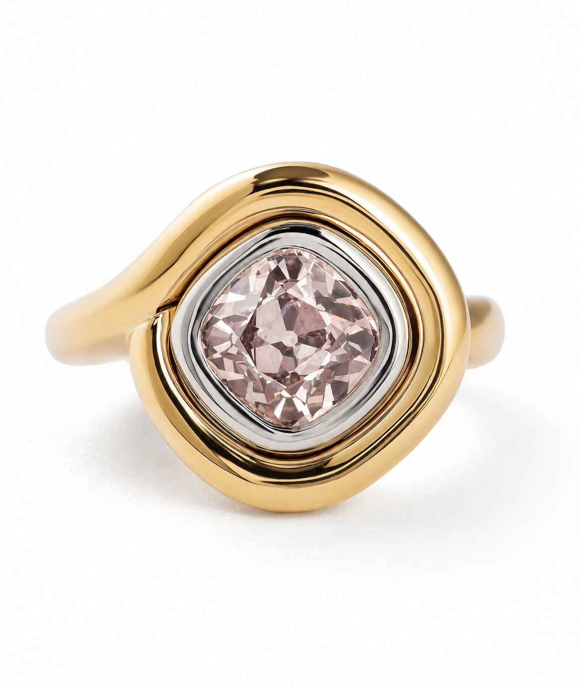 A gold ring with a wavy, rounded bezel setting holding a cushion-cut pale pink gemstone, shown on a clean white background.