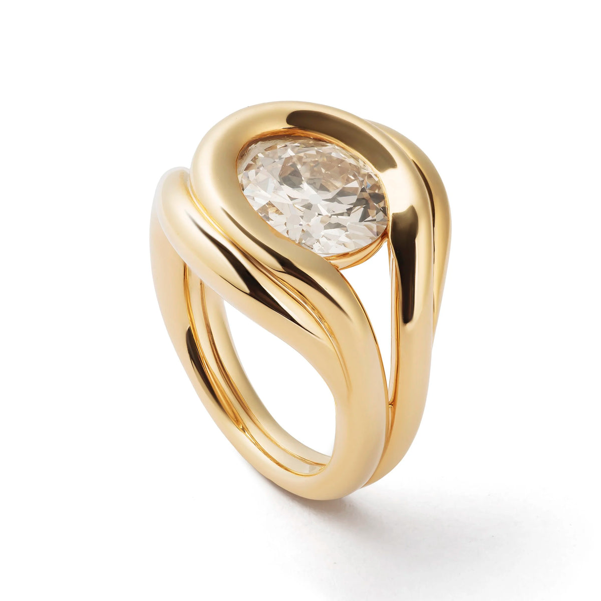 A gold ring with a twisted, sculptural band and a large oval clear gemstone in the center, shown on a clean white background.