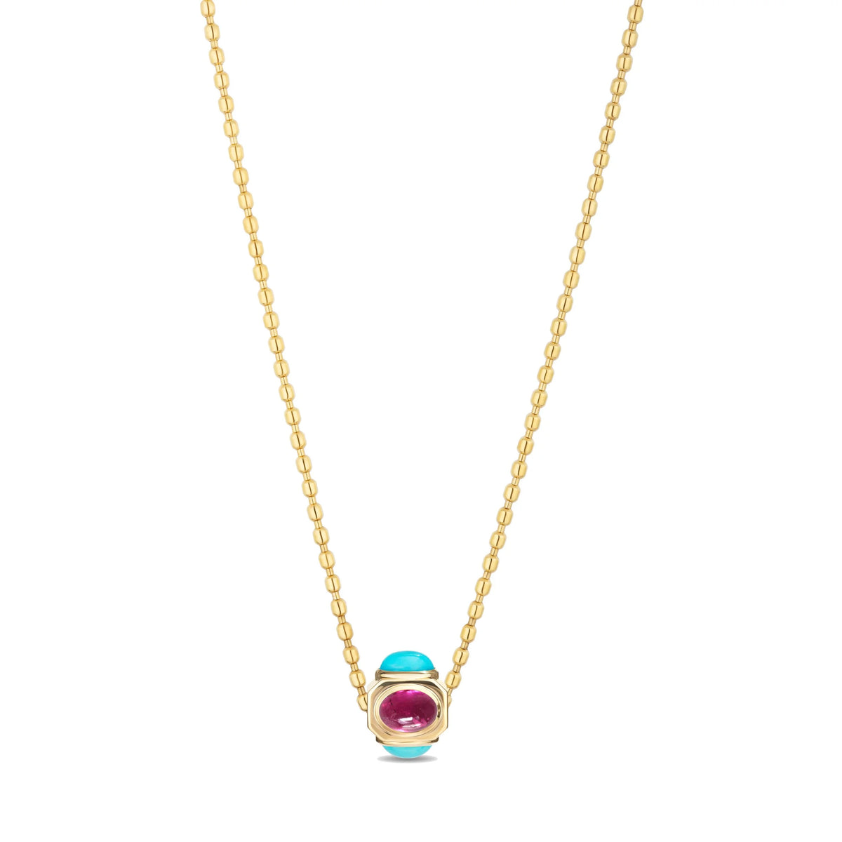 A gold chain necklace featuring a small pendant with a turquoise blue stone and a pinkish-red stone, set against a plain white background.