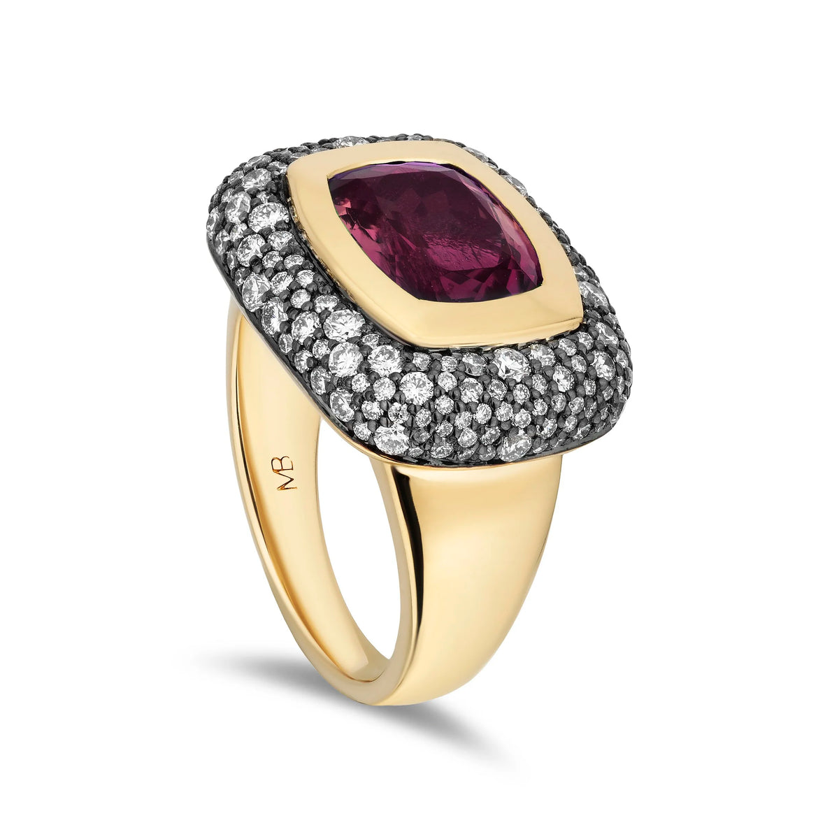 A yellow gold ring featuring a cushion-cut deep rubellite center stone surrounded by a halo of small pavé-set clear stones, on a plain white background.