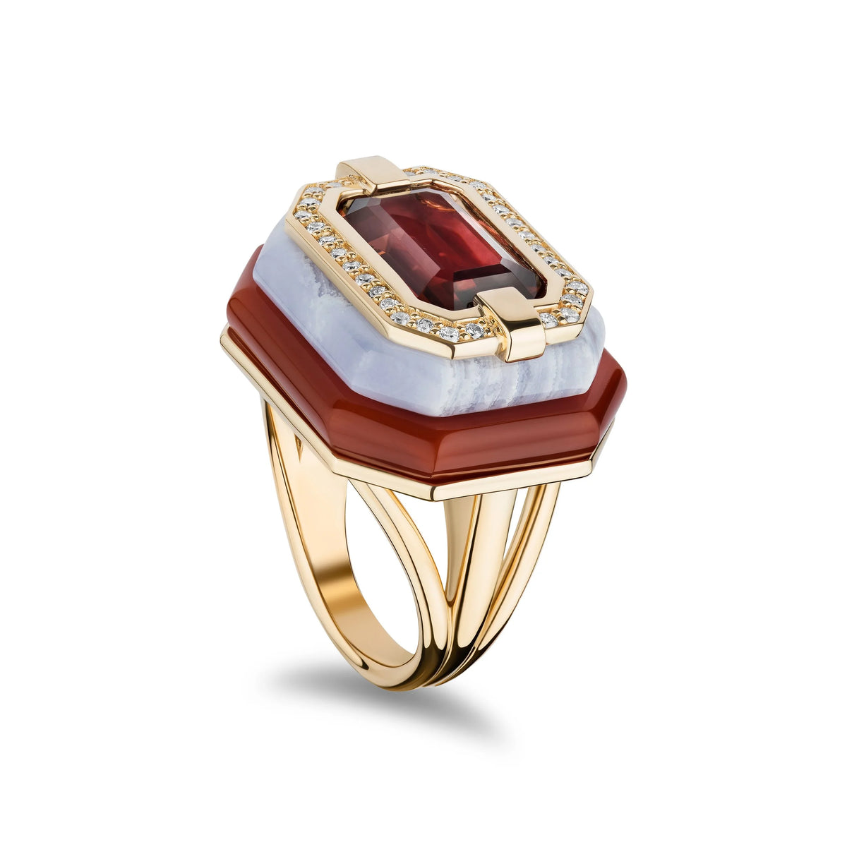 A luxury gold ring featuring a large rectangular red garnet center stone, surrounded by a halo of small clear pavé diamonds and a smooth light blue-white onyx band, with a wider dark red onyx outer band and a polished gold split-shank band.
