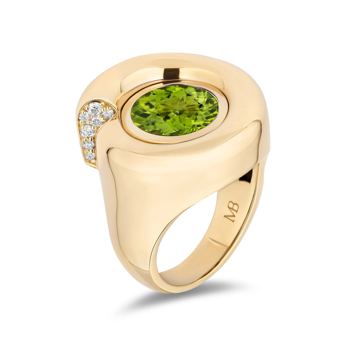 A yellow gold signet ring featuring a large oval-cut green peridot center stone and a curved row of small clear stones on the side, shown on a clean white background.