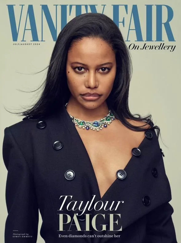 Vanity Fair magazine cover featuring Tayour Paige, wearing a black double-breasted coat with large buttons and a colorful diamond necklace.