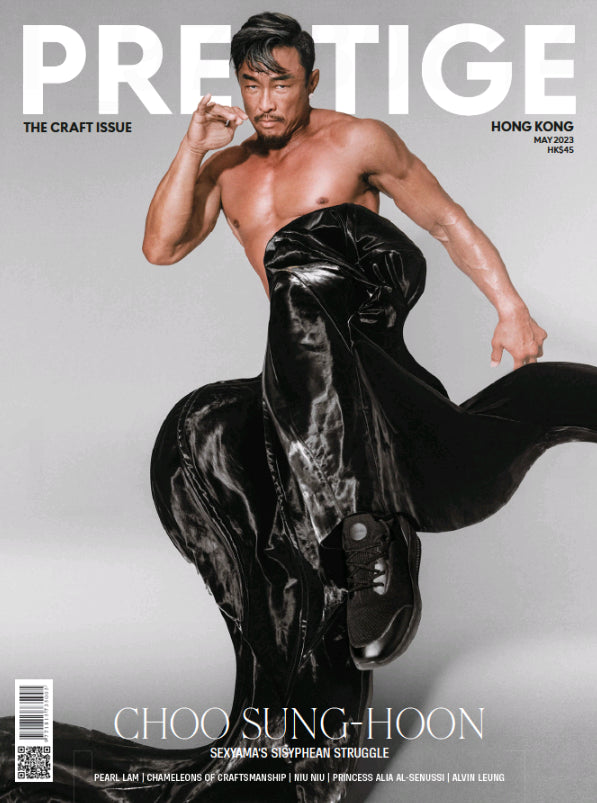 A shirtless man with black hair and a beard poses on the cover of Prestige magazine.