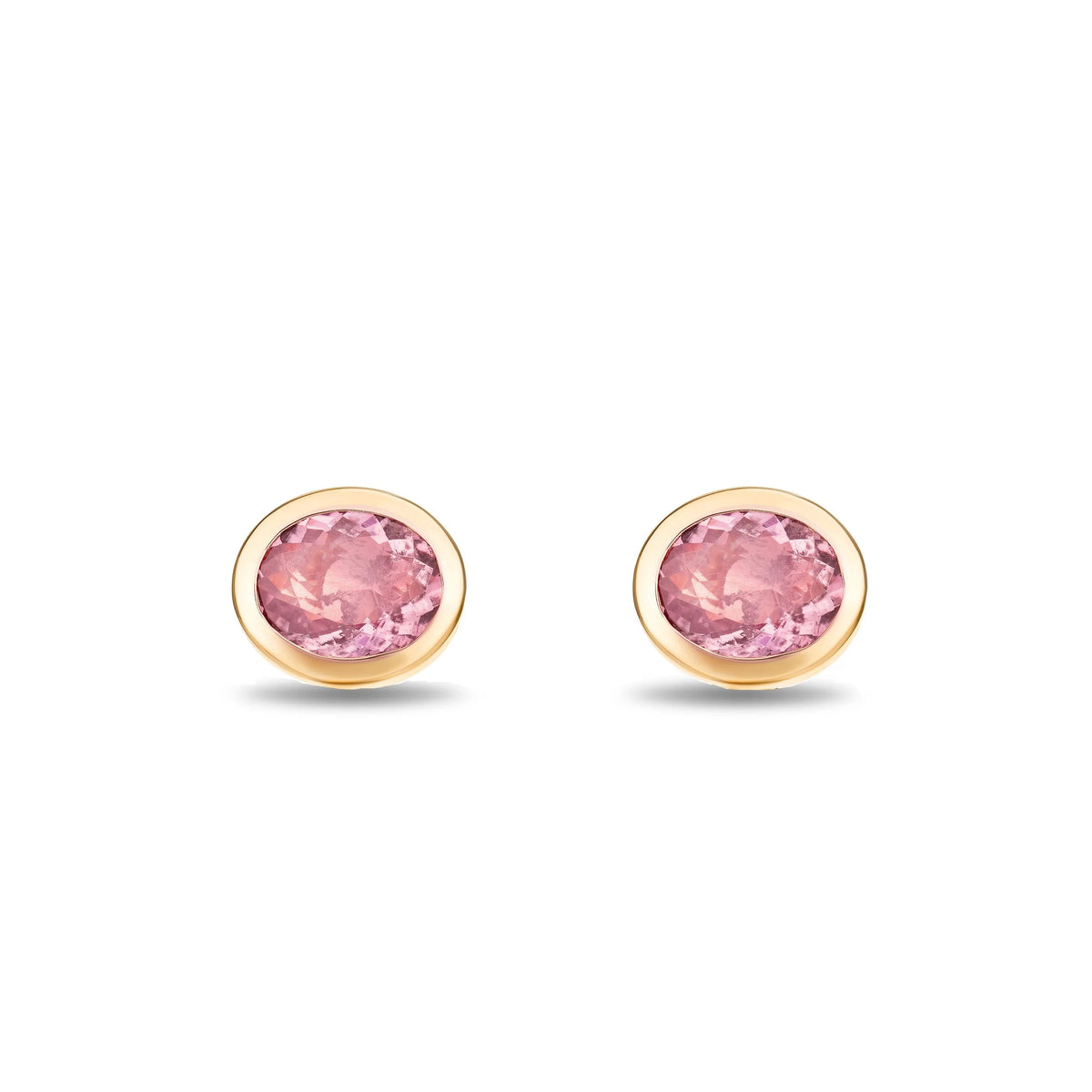 A pair of oval stud earrings with pink gemstones in gold bezel settings, shown on a clean white background.