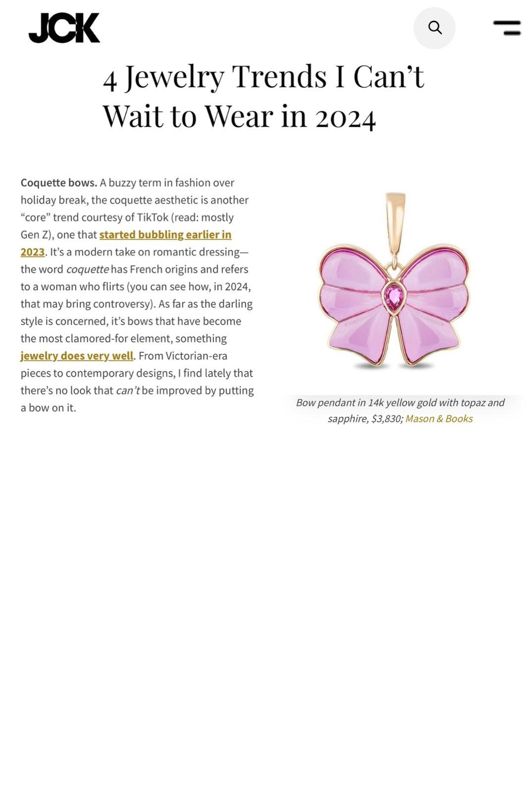 Web article featuring a pink butterfly-shaped pendant with a pink gemstone at the center, set in 14k yellow gold, costs $3,830.