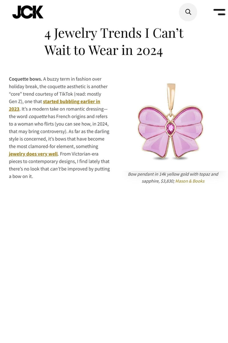 Web article featuring a pink butterfly-shaped pendant with a pink gemstone at the center, set in 14k yellow gold, costs $3,830.