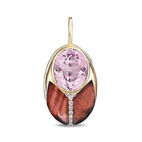 An oval pendant featuring a large faceted pink gemstone at the top, a polished gold setting, and a curved reddish-brown inlay below, accented by a small line of clear stones, shown on a white background.