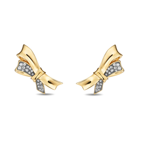 A pair of gold bow-shaped stud earrings with pavé-set clear stones on the side, shown on a plain white background.
