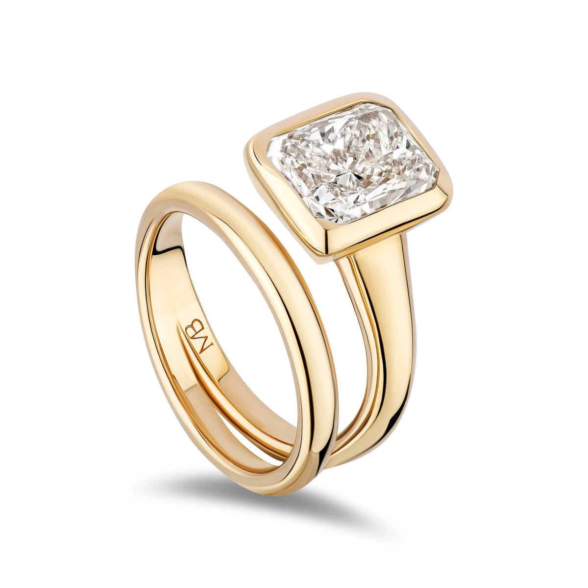 A yellow gold ring set featuring a square radiant-cut diamond solitaire and a matching slim band, shown on a clean white background.