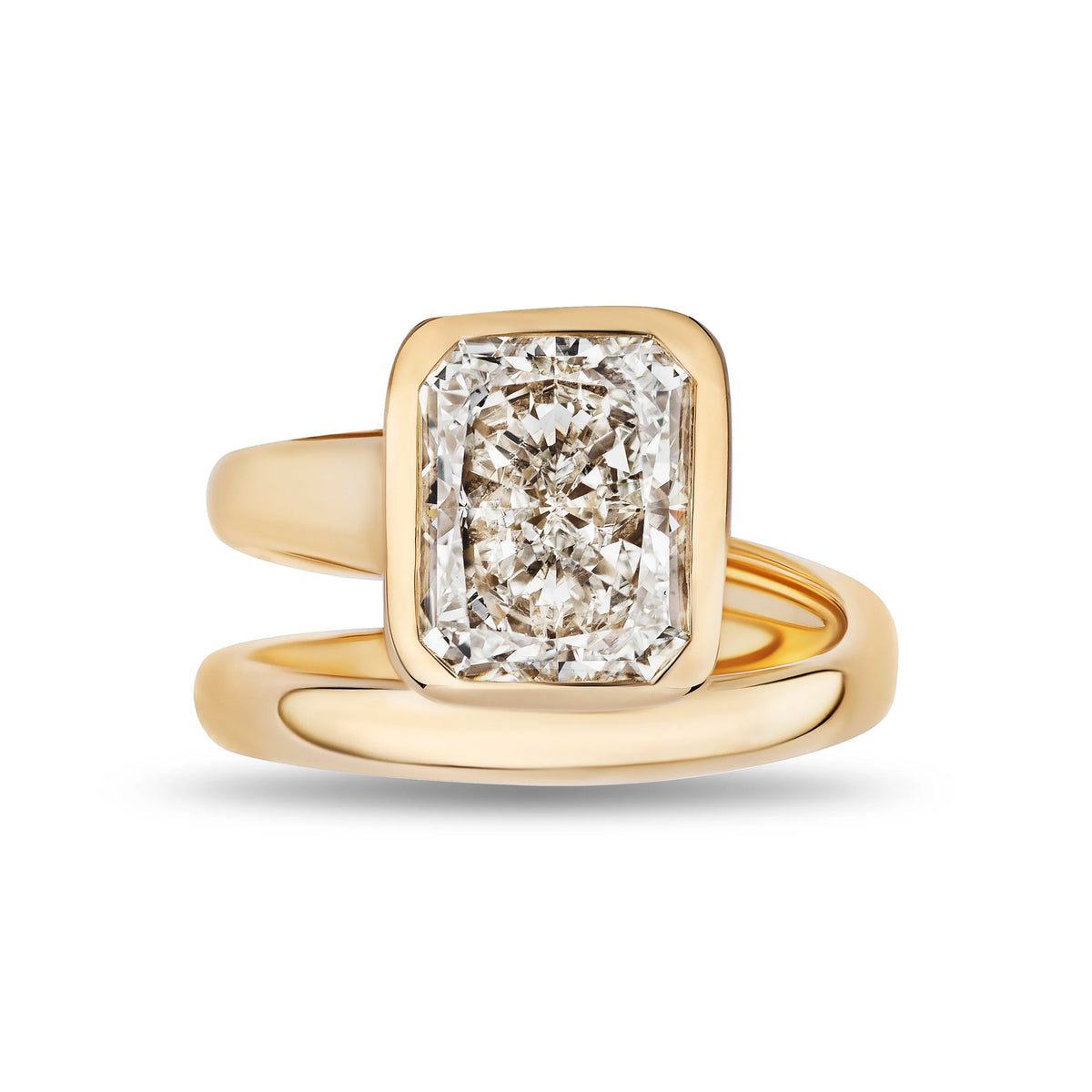 A yellow gold ring featuring a large rectangular cushion-cut diamond in a bezel setting, with a polished shank that wraps around the band, shown on a white background.
