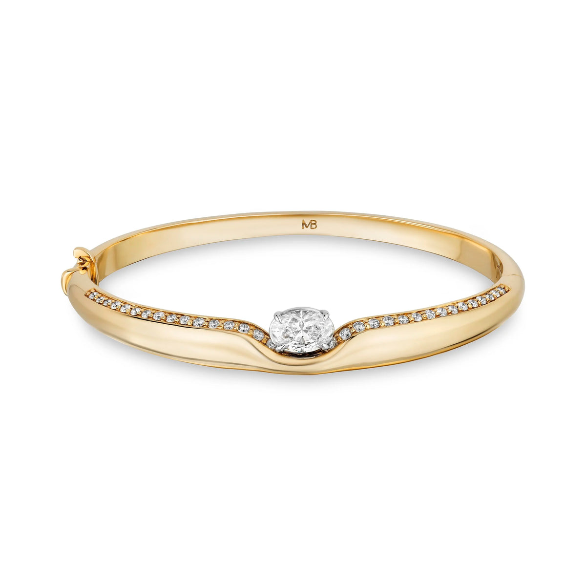A yellow gold hinged bangle bracelet featuring a curved channel set with small pavé diamonds and a central round-cut diamond, shown on a clean white background.