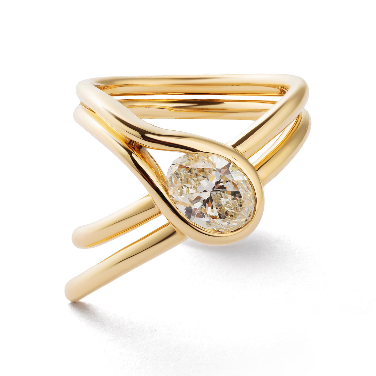 A gold ring with a multi-band wrap design and a round brilliant-cut diamond set in the center, shown on a clean white background.