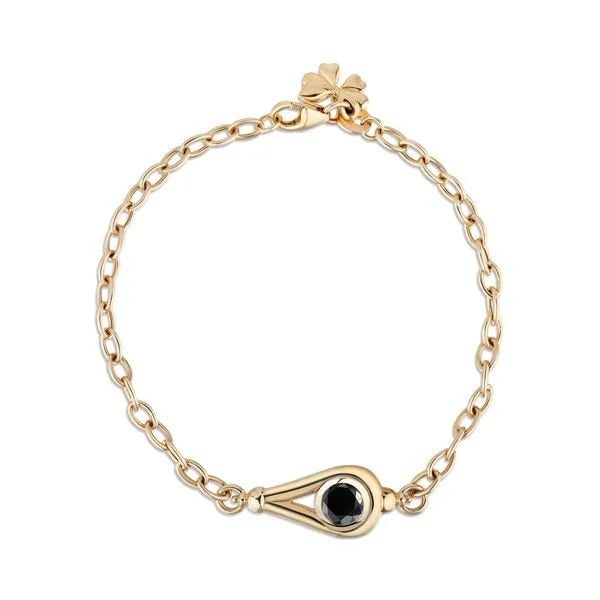 A gold chain bracelet with a small clover charm at the clasp and a teardrop-shaped gold centerpiece featuring a round black diamond, shown on a plain white background.