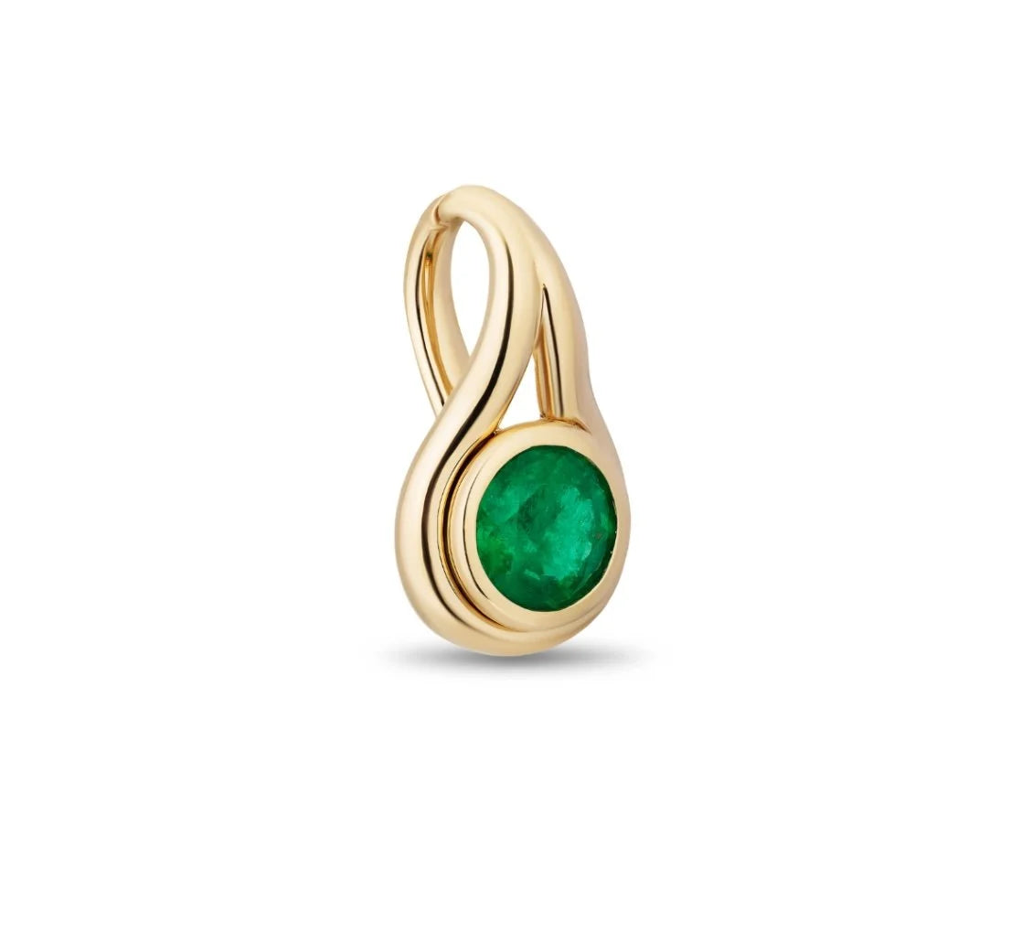 A gold lasso pendant charm featuring a round, bezel-set emerald green gemstone, shown on a clean white background.