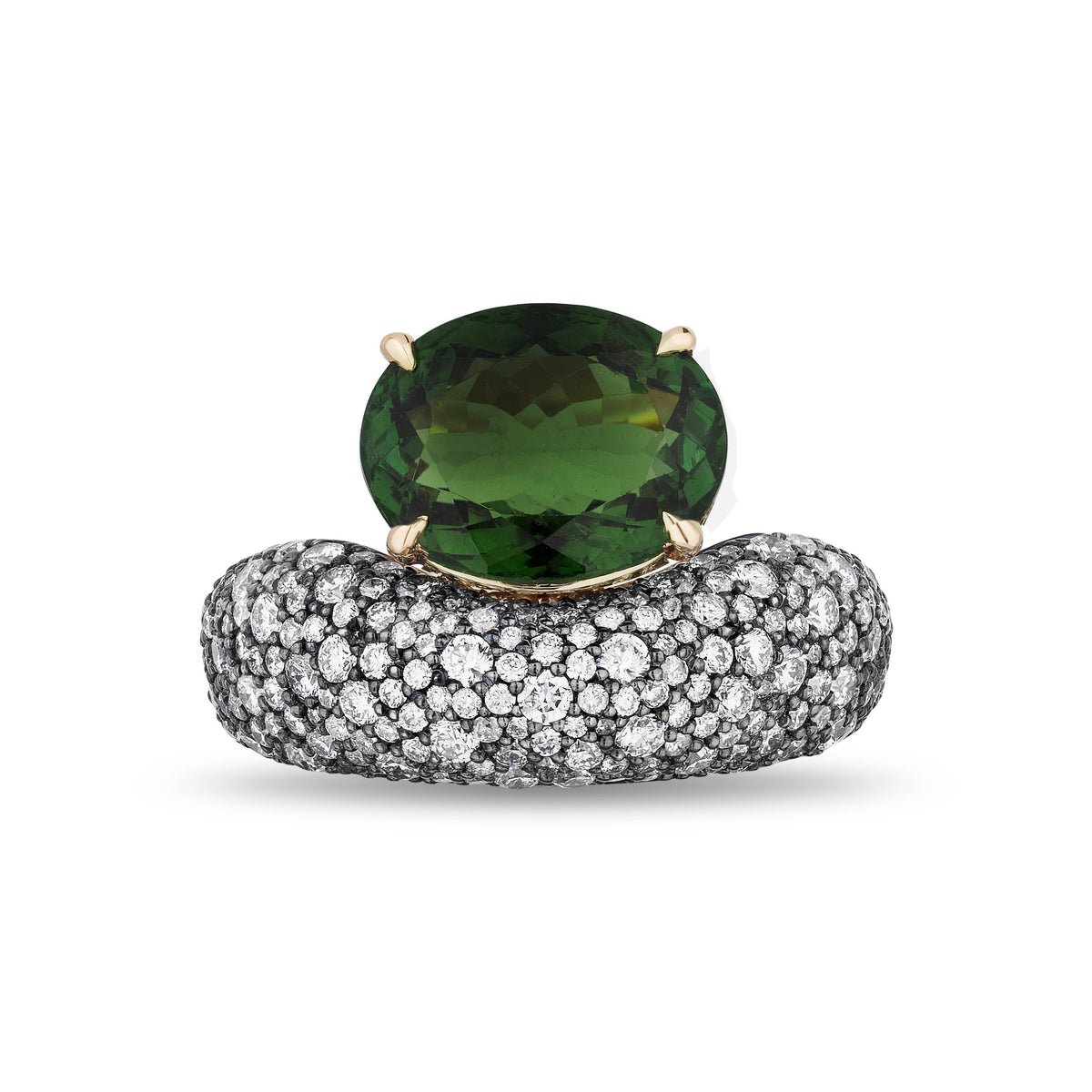 An oval-cut green gemstone ring set in yellow gold, resting on a curved band paved with small clear stones, photographed on a clean white background.