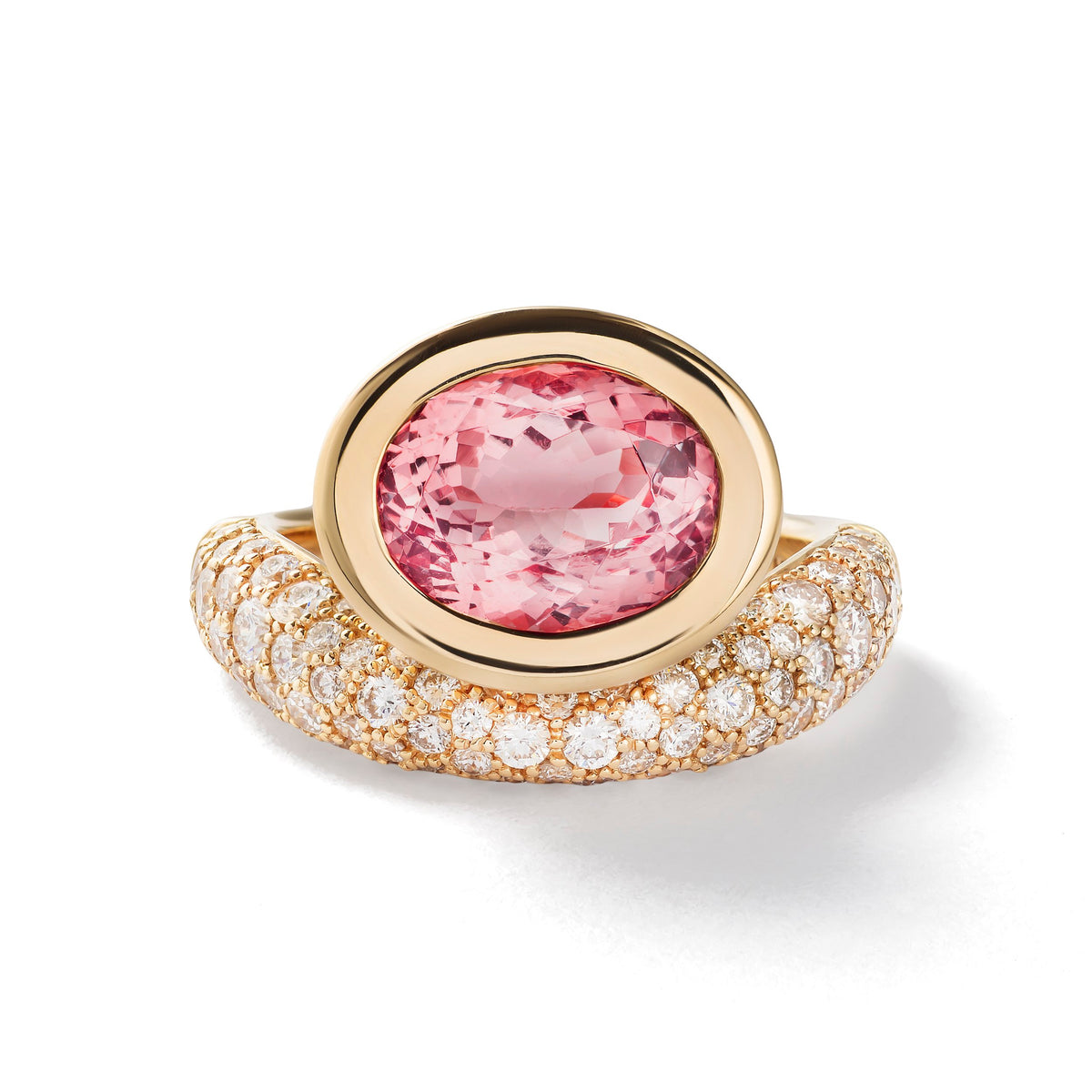A gold ring featuring a large oval pink tourmaline in the center, surrounded by a halo and a pavé-set band of small clear stones, shown on a white background.