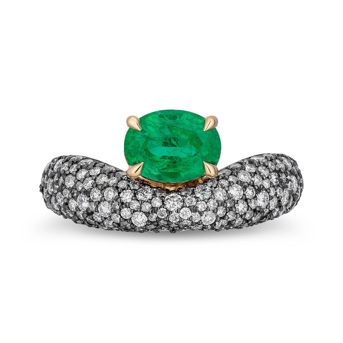 An oval-cut green emerald ring set in yellow gold on a pavé diamond band, photographed on a clean white background.