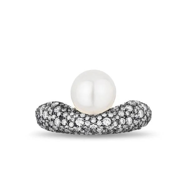 A white pearl ring featuring a round white pearl set in a curved band paved with small pave diamonds, shown on a plain white background.