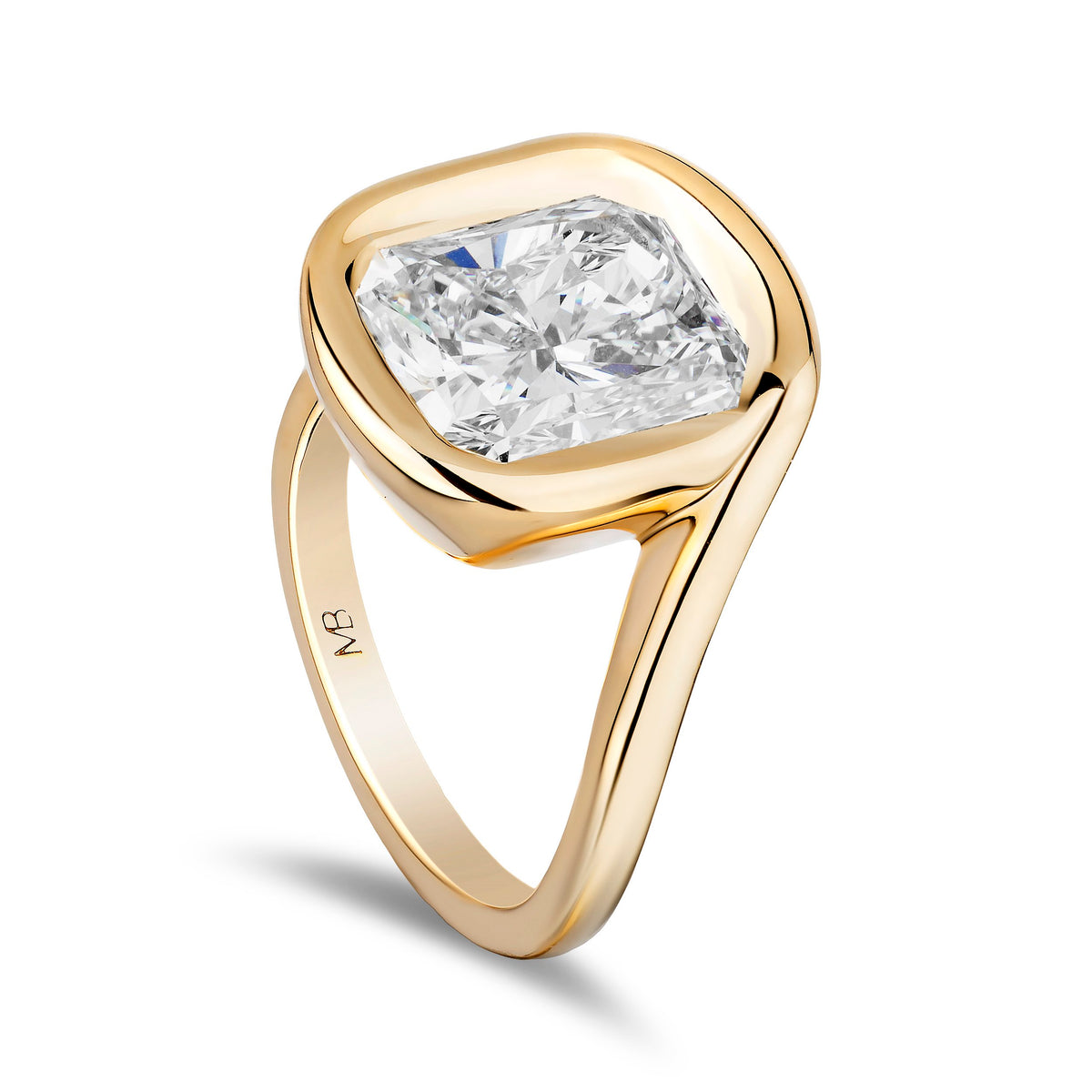 A yellow gold ring featuring a large cushion-cut diamond in a bezel setting with a split shank band, shown on a clean white background.